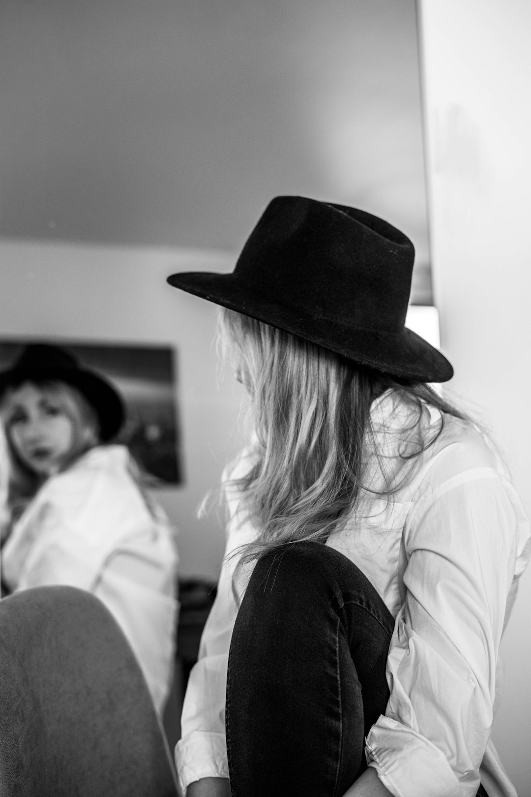 woman in white shirt and black hat