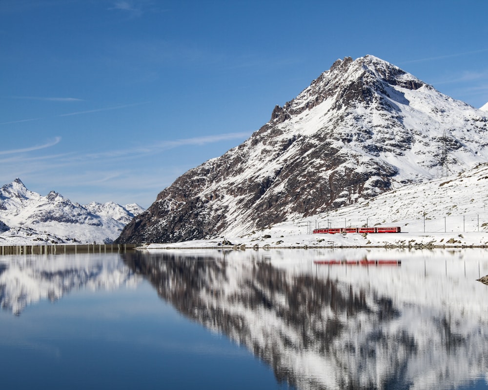 white and black mountain near body of water during daytime