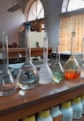 clear glass bottles on brown wooden table