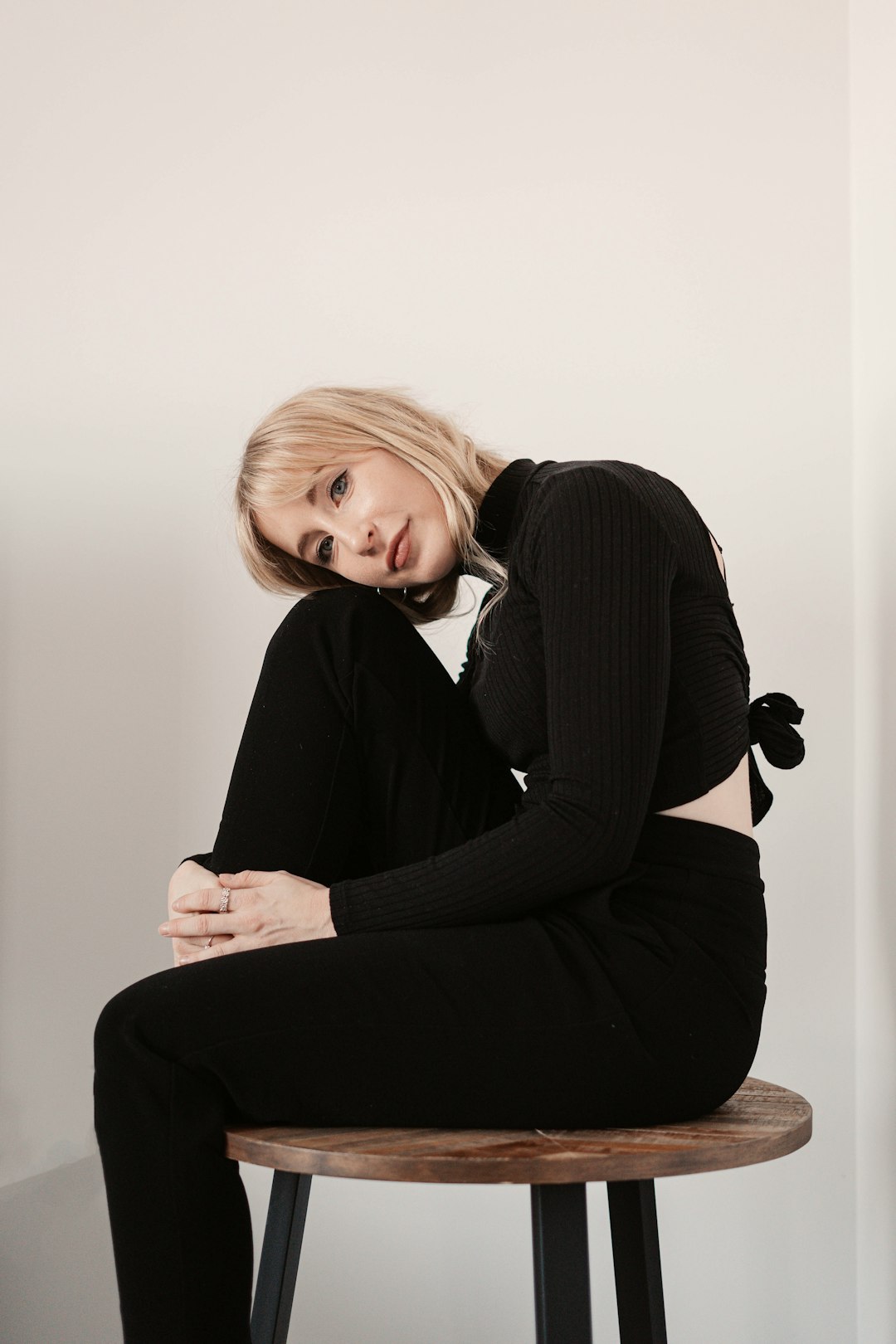 woman in black long sleeve shirt sitting on black chair