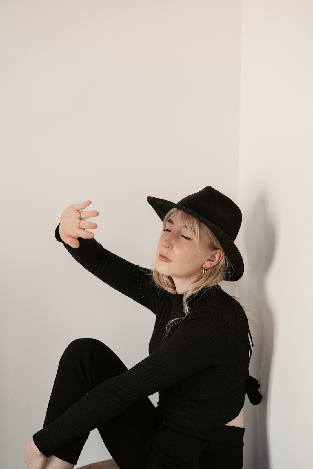 woman in black long sleeve shirt wearing black hat
