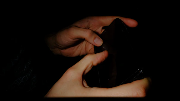 Close-up of sleek mobile app interface held against a neutral dark background.