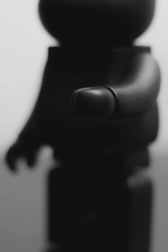 Close-up photo of a matte navy blue 3D printed fan art figurine with intricate details