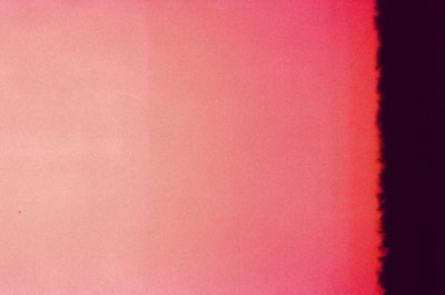 A gradient image with shades of red and pink fading from left to right, ending in a dark black stripe on the far right edge.
