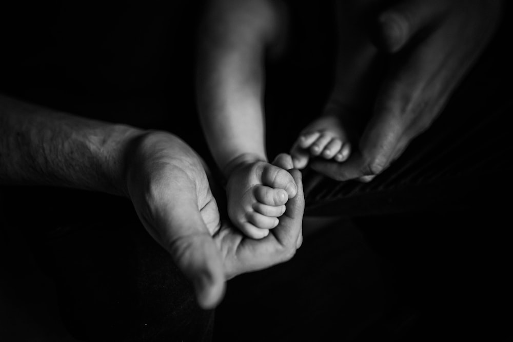 grayscale photo of babys feet