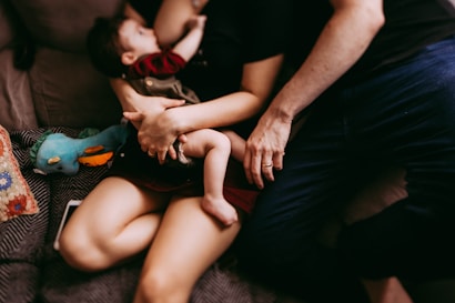 A comforting scene inside a perinatal psychology center, showing a counselor gently supporting a mother.
