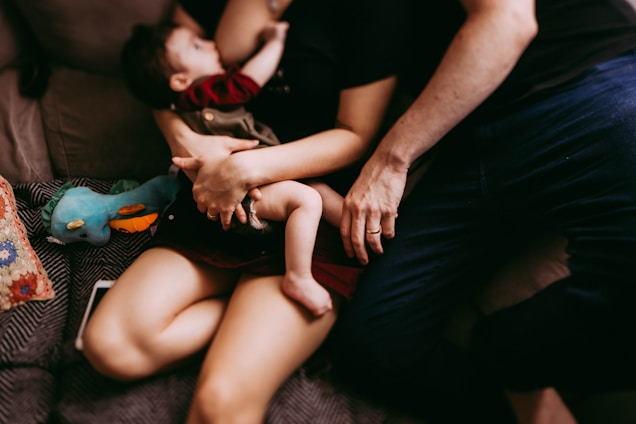 A warm and inviting scene of a mother holding her baby in a cozy setting.