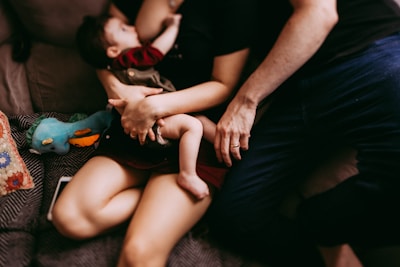 A cozy scene showing a mother gently cradling her baby surrounded by soft baby products.