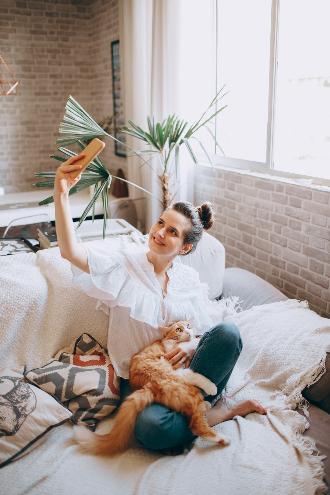 woman in white long sleeve shirt lying on bed