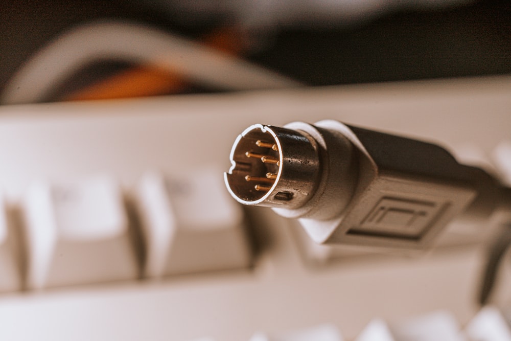 black and silver microphone on white computer keyboard