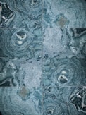 Close-up of elegant marble tiles with subtle blue veins reflecting soft light.