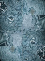 The image features a detailed close-up view of marble or stone tiles with intricate swirling patterns in shades of blue and gray. The tiles are arranged in a symmetrical pattern, creating a visually pleasing and consistent design.