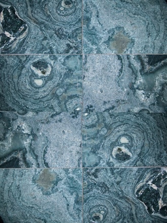 A collection of elegant marble tiles in various colors and patterns arranged aesthetically.