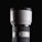 A large, white telephoto camera lens with a black cap, featuring fine ribbed texture on the adjustable rings. The brand logo is displayed on the upper part of the lens. The background is a solid black, highlighting the sleek and professional design of the lens.