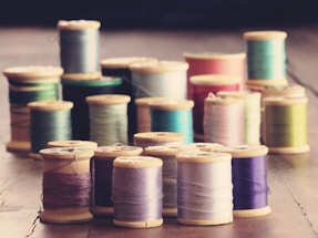 white blue and pink thread rolls