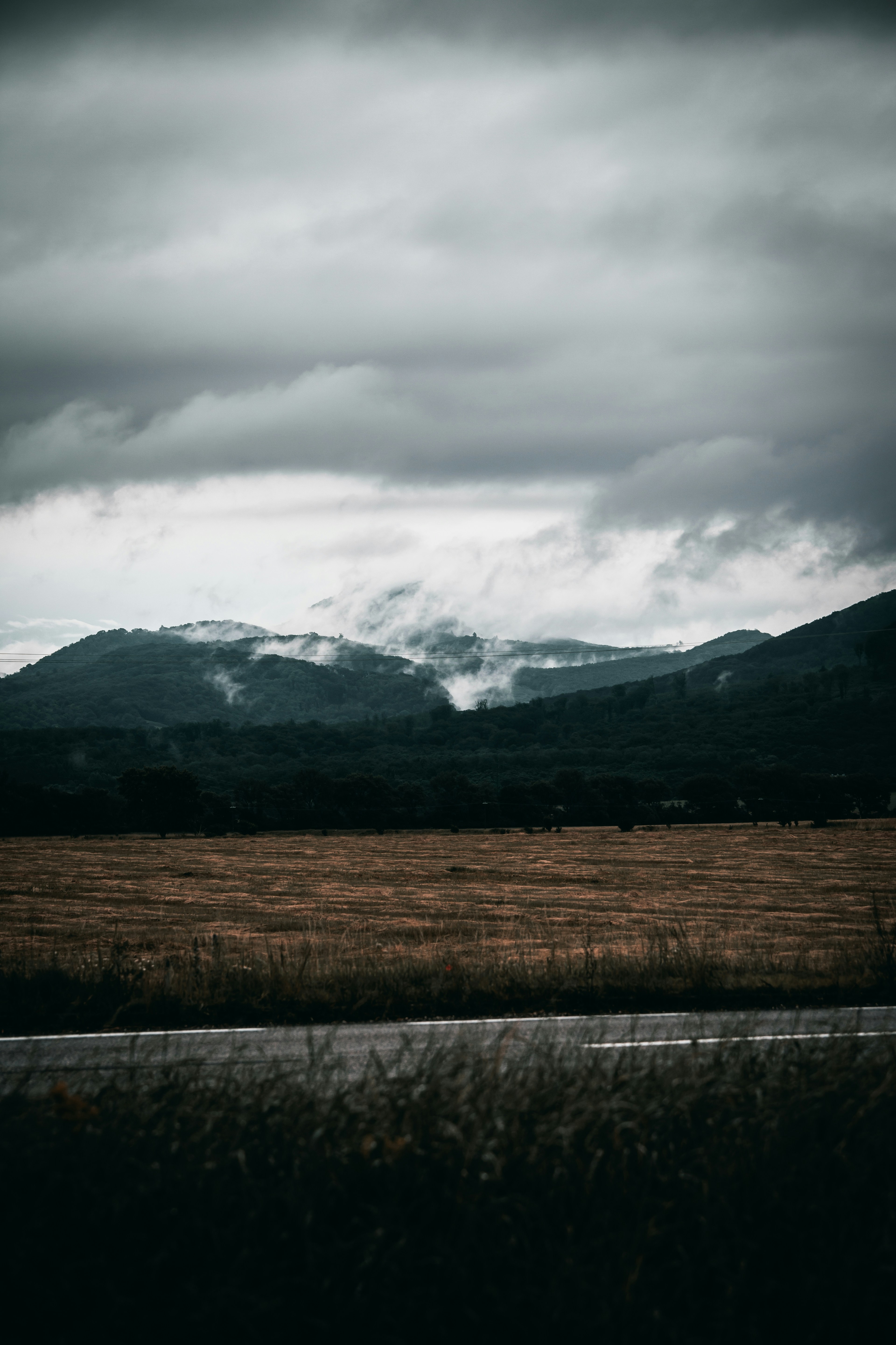 Brown Grass Field Near Mountain Under White Clouds During Daytime Photo Free Grey Image On Unsplash