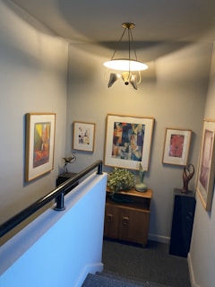 A well-decorated hallway with art and lighting.