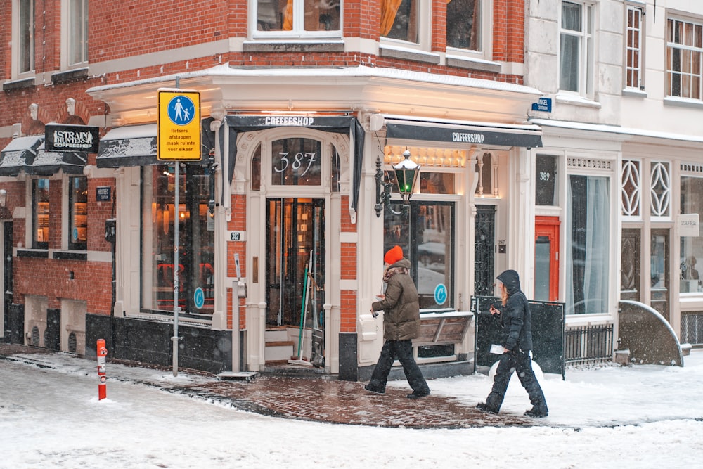 person in black jacket walking on sidewalk during daytime