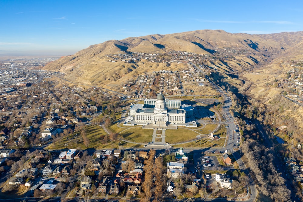 white concrete building on top of brown mountain during daytime