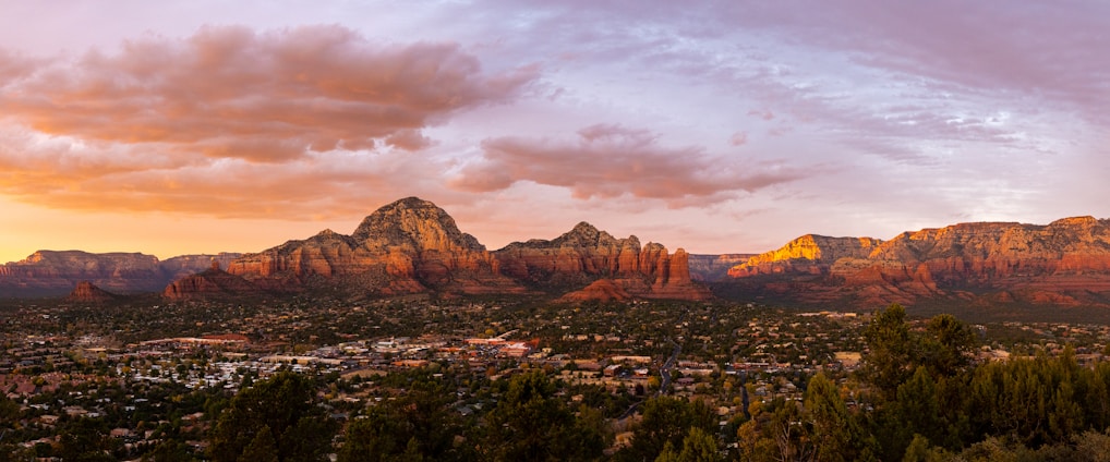 A scenic view of the Verde Valley highlighting the Sedona red rocks at sunset.