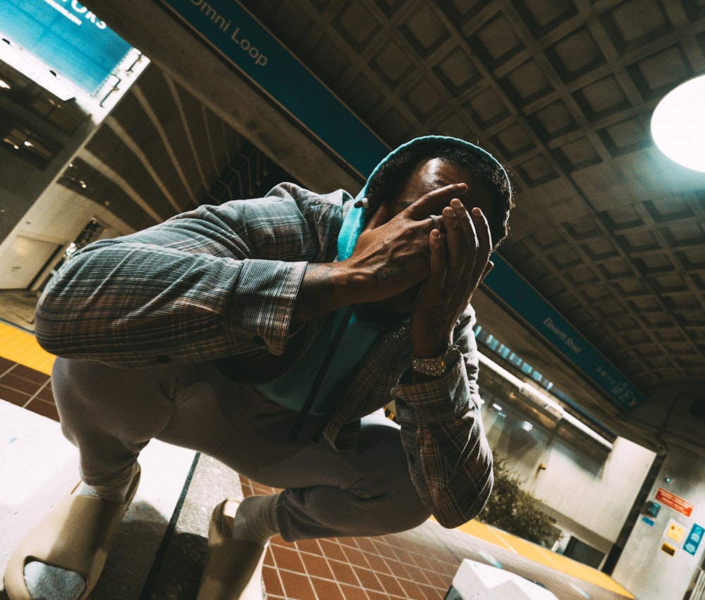 man in blue denim jacket and black and white nike cap