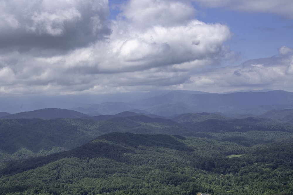 green mountains under white clouds during daytime