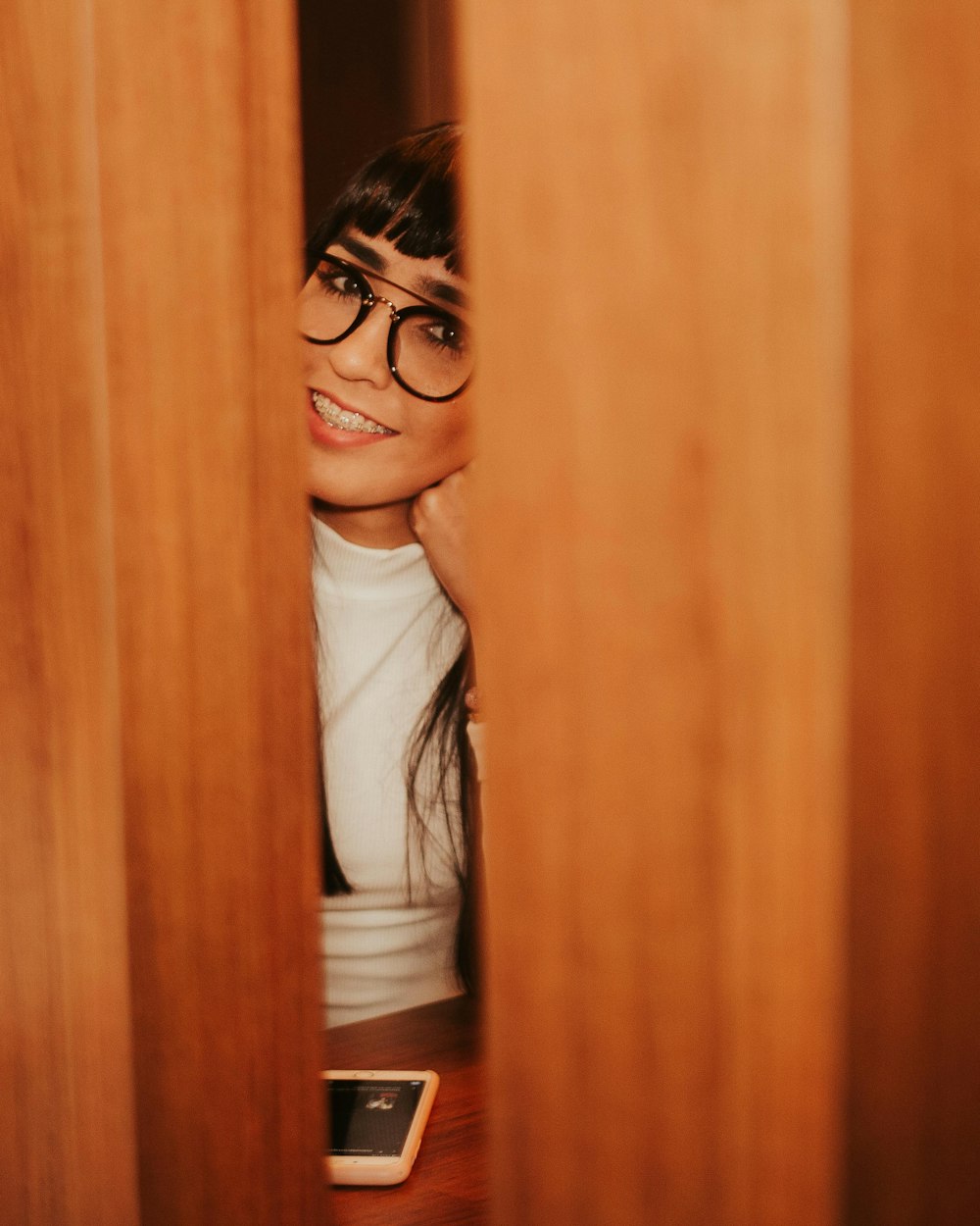 woman in white long sleeve shirt wearing black framed eyeglasses