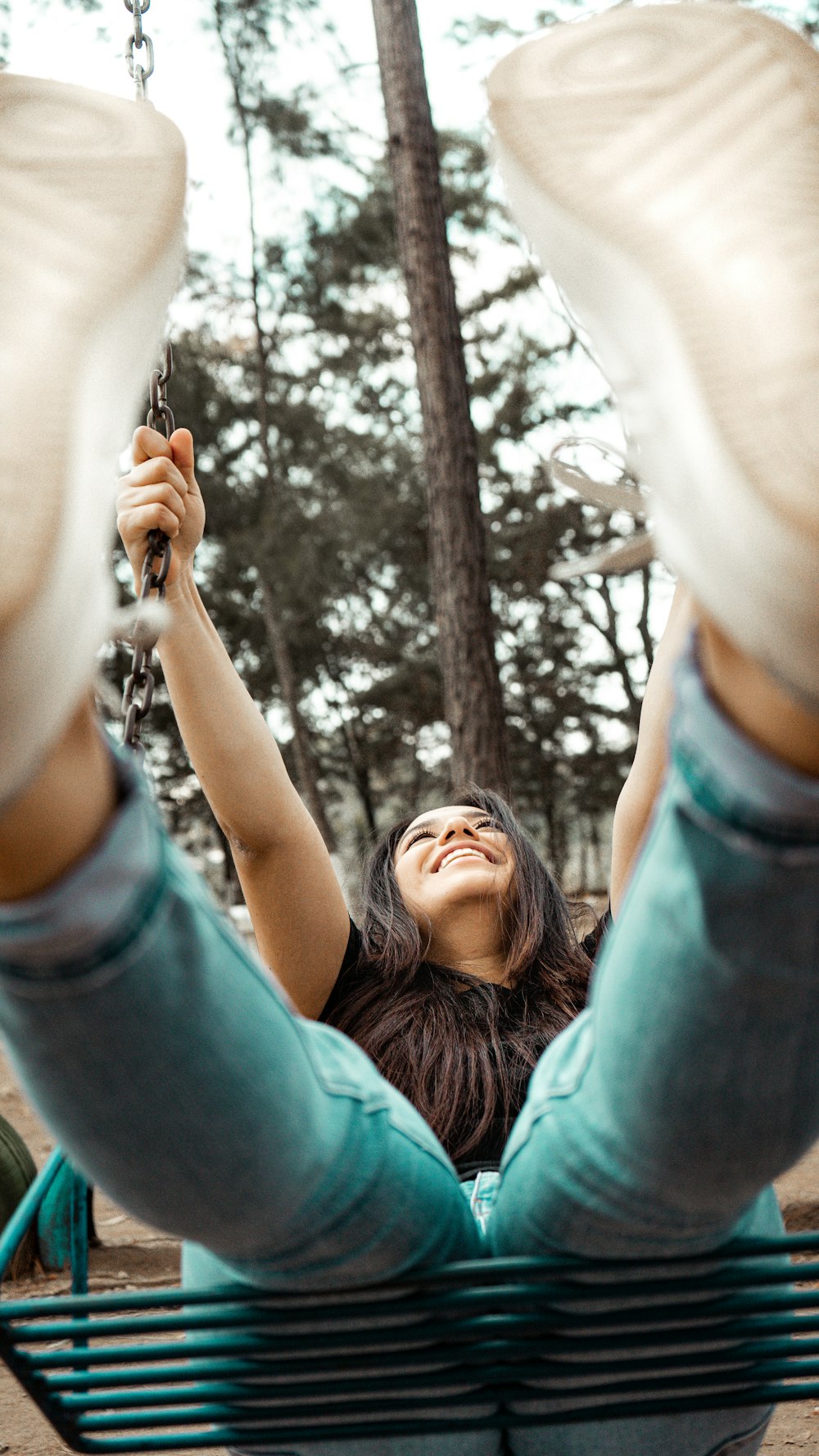 woman in blue denim jacket raising her hand