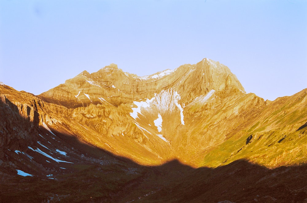 brown and white mountain under blue sky during daytime