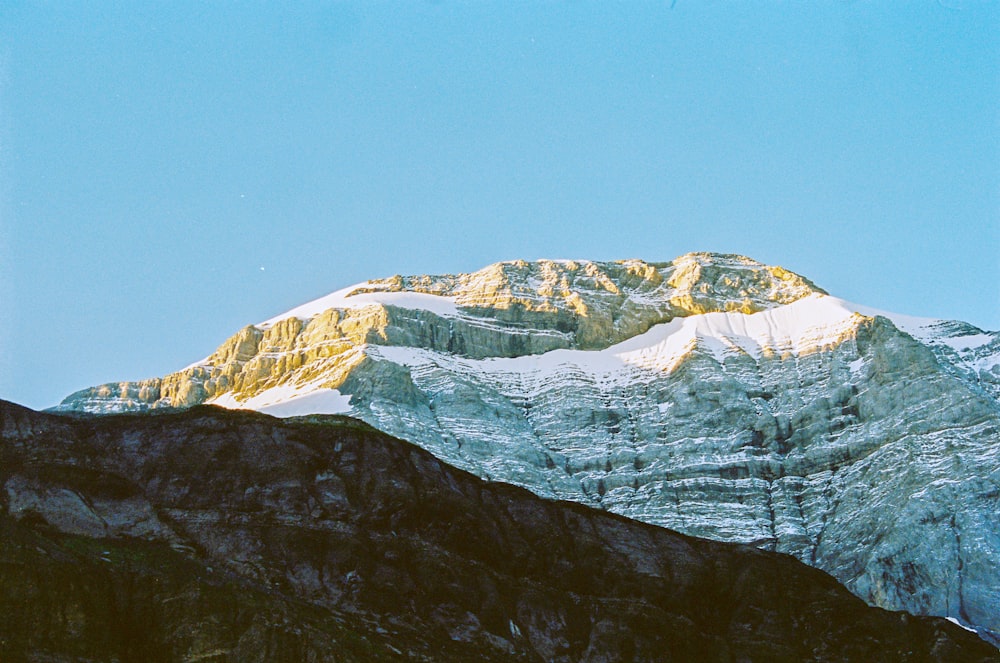 snow covered mountain under blue sky during daytime