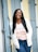 woman in white long sleeve shirt and blue denim jeans standing beside white wooden door during