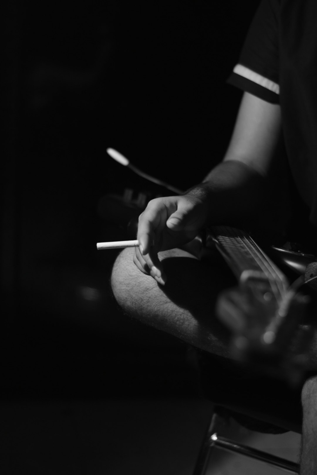 person holding cigarette stick in grayscale photography