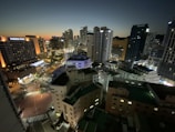 View from the hotel room window overlooking the city skyline at dusk.