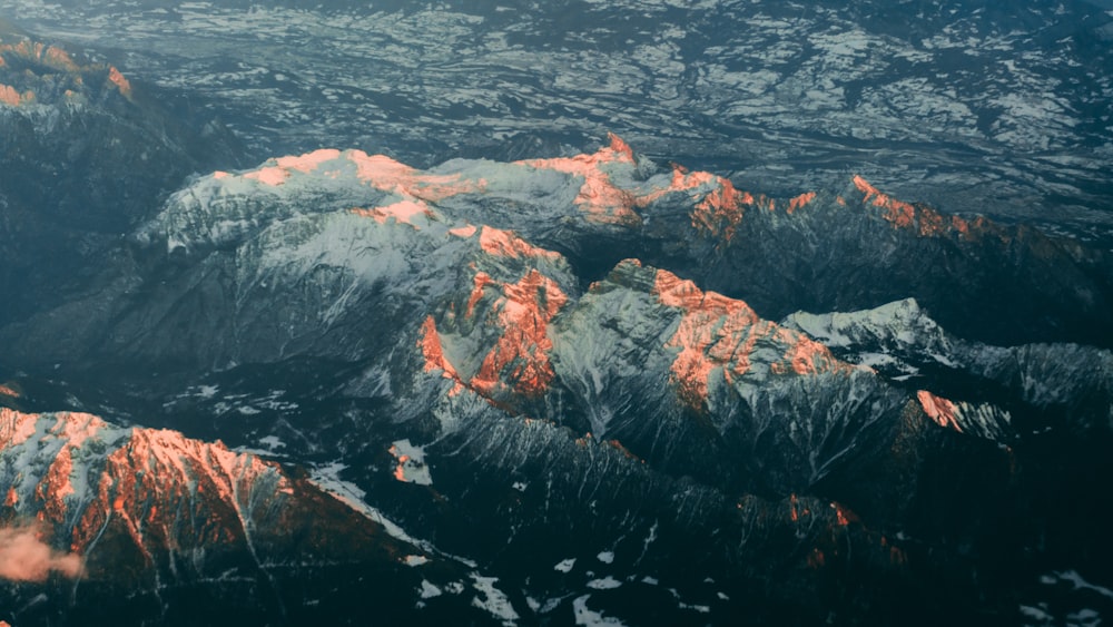 white and black mountain near body of water