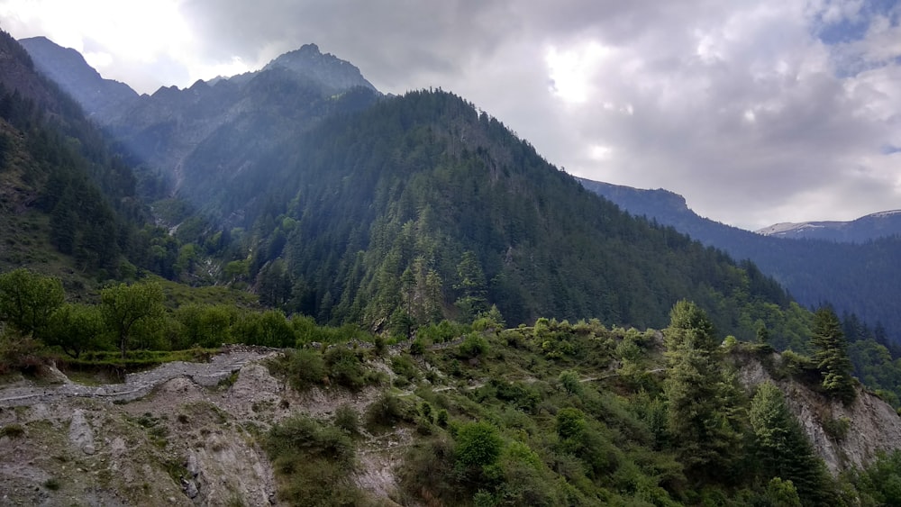 green mountain under white clouds during daytime