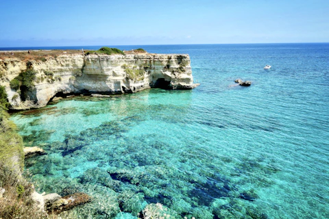 brown rock formation on blue sea during daytime