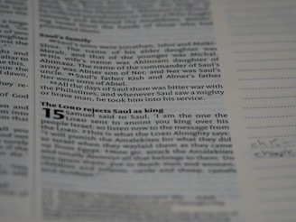 A close-up of hands editing a printed book layout on a desk