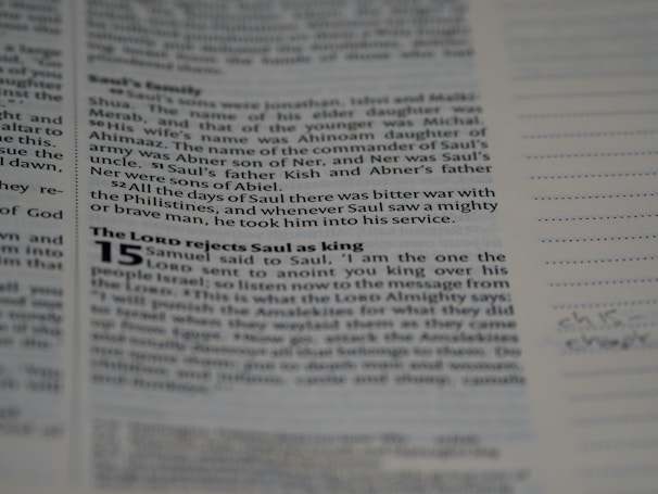 A close-up of hands editing a printed book layout on a desk