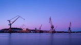 crane near body of water during daytime