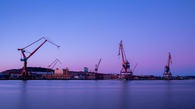 crane near body of water during daytime