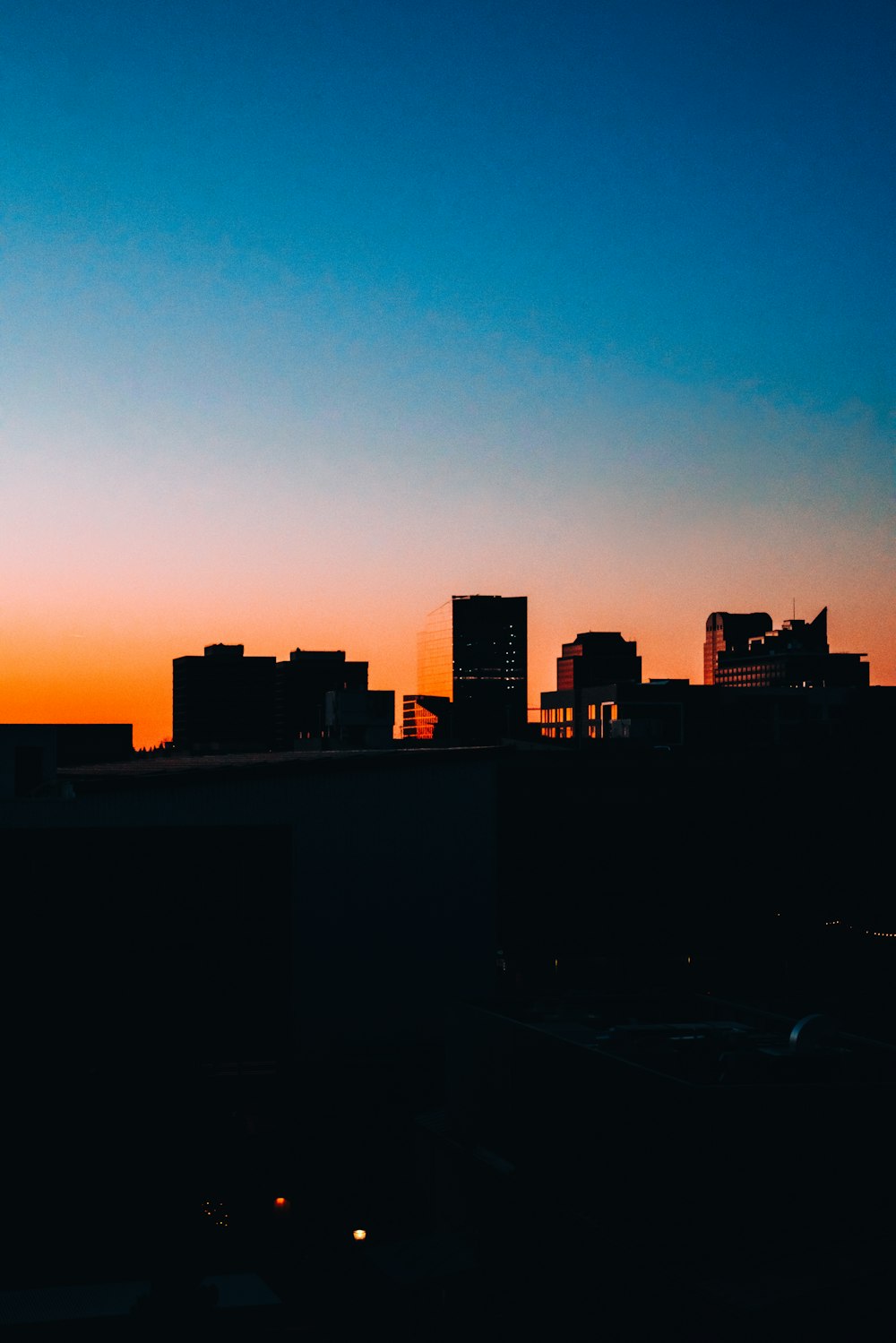 silhouette of city buildings during sunset