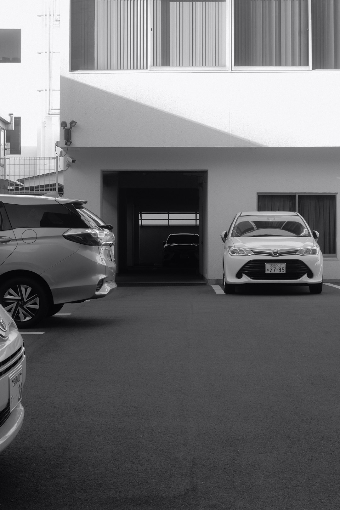 grayscale photo of car parked in garage