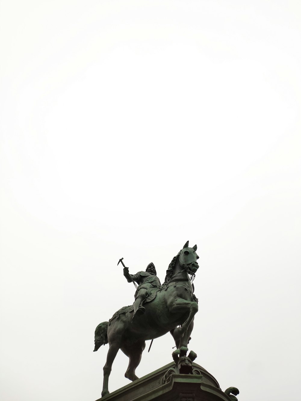 man riding horse statue during daytime