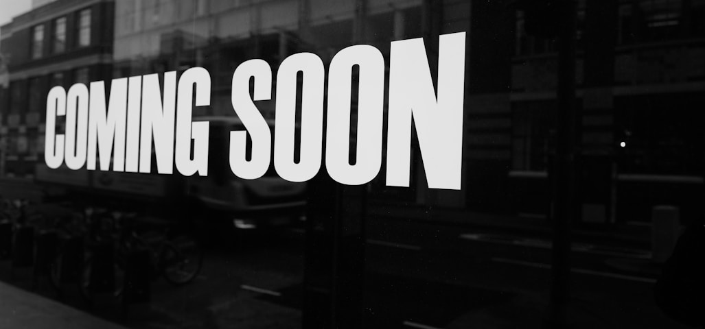 a black and white photo of a sign that says coming soon