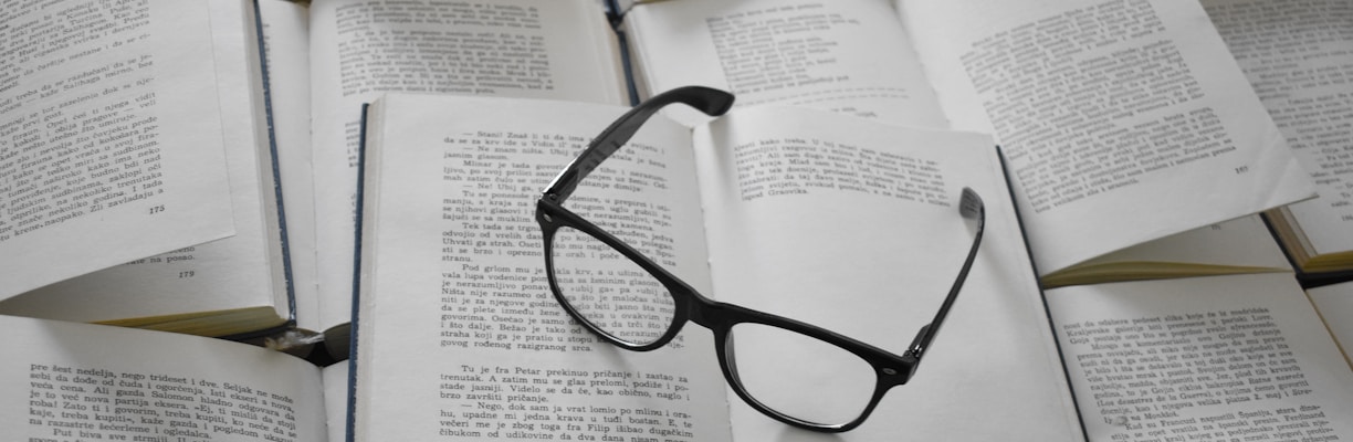 black framed eyeglasses on white book page
