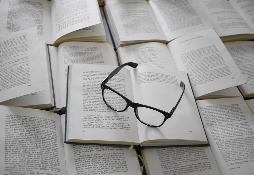 black framed eyeglasses on white book page