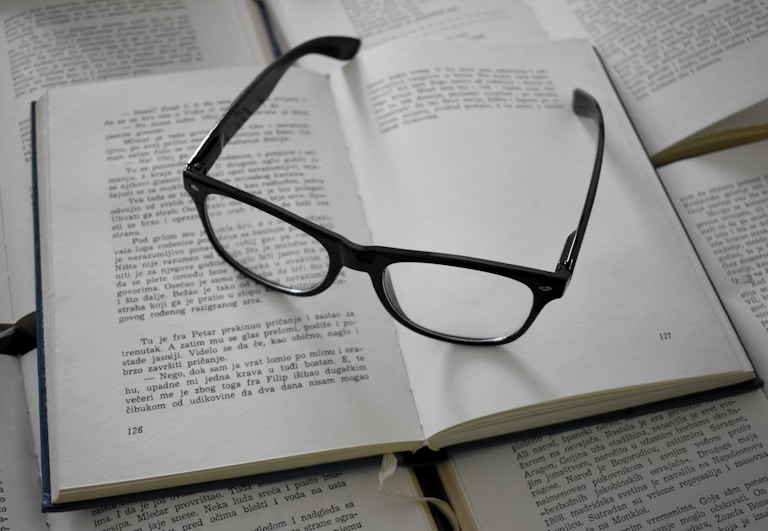 black framed eyeglasses on white printer paper