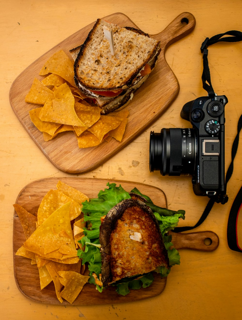 black dslr camera on brown wooden table