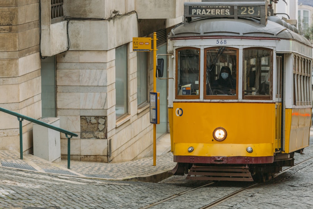 yellow and white tram on road during daytime