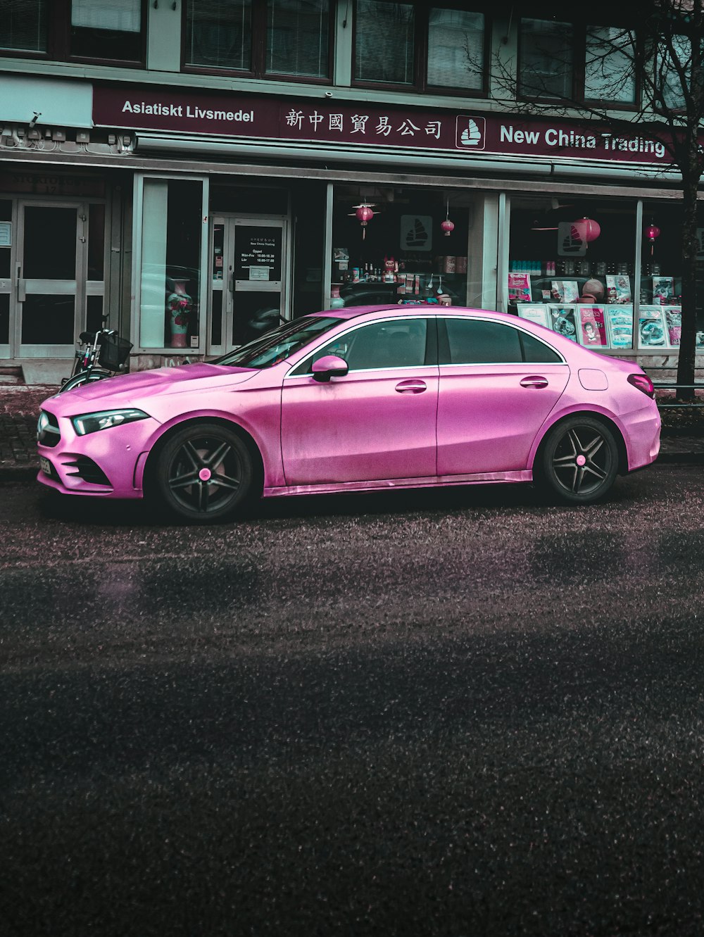 pink porsche 911 parked near white building during daytime